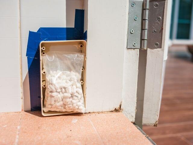 Electrical box with pills outside building for medication management.